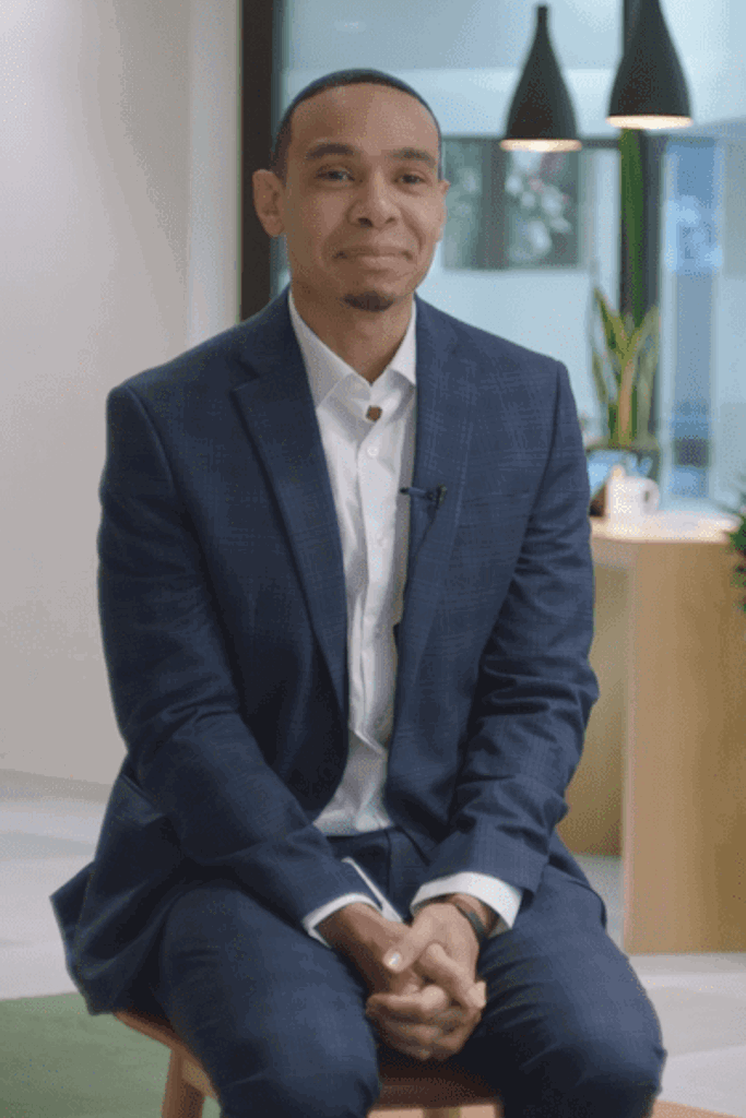 a person in a suit sitting in a chair