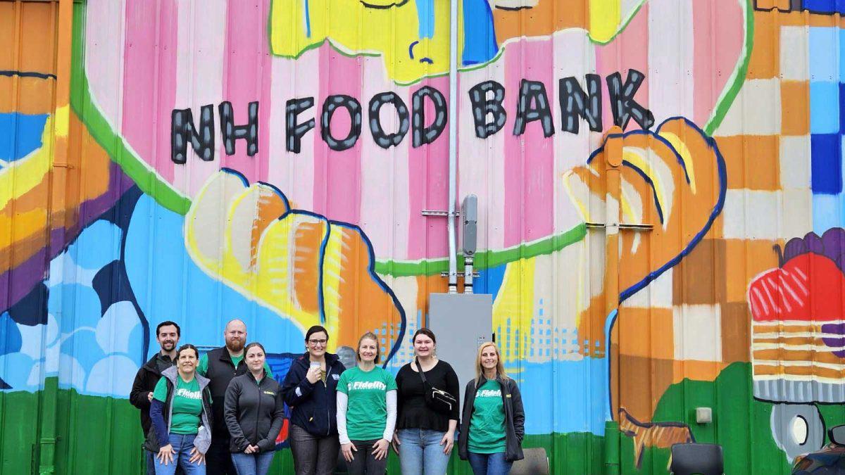 a group of people posing for a photo in front of a colorful wall